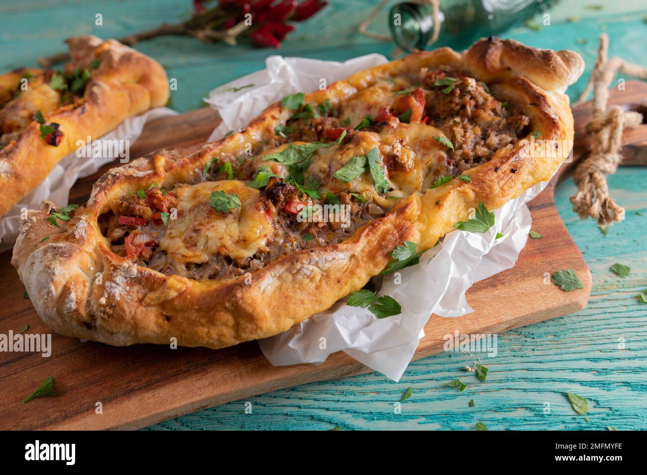 Turkish pide with ground beef and cheese topping Stock Photo