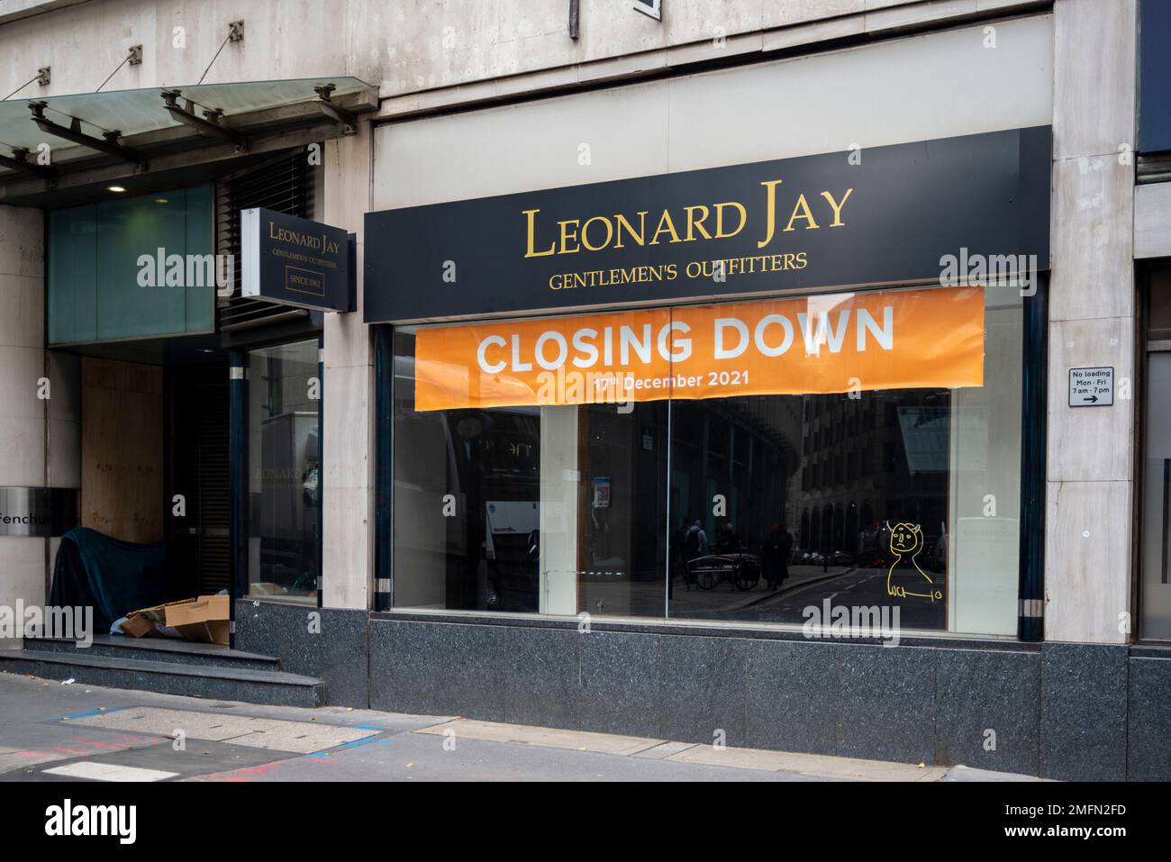 Closed down Leonard Jay gentleman's outfitters clothing shop. Empty window with homeless bedding in doorway Stock Photo