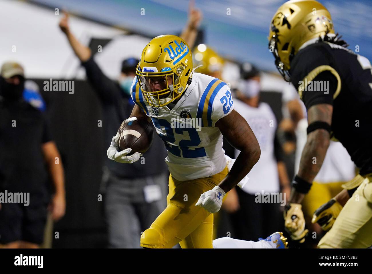 UCLA running back Keegan Jones, left, runs for a touchdown as Colorado