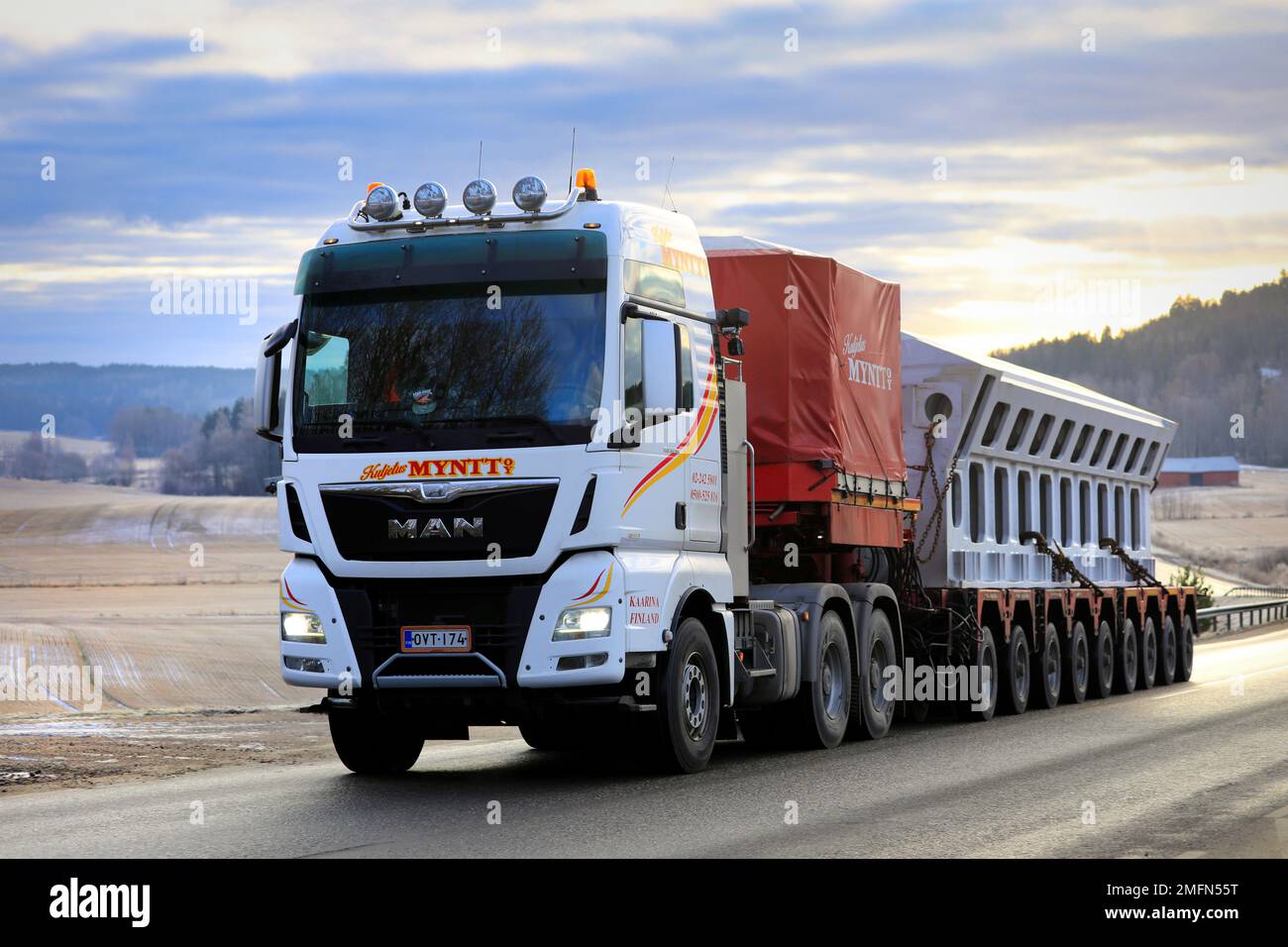 MAN TGX 33.580 truck Kuljetus Myntt Oy transports industrial object as oversize load on multi-axle trailer. Salo, Finland. January 20, 2023. Stock Photo