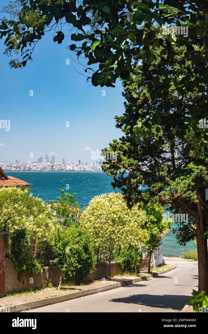 View from the street with beautiful blooming gardens and trees to the Marmara Sea on the Adalar Islands. Istanbul, Turkey. Stock Photo