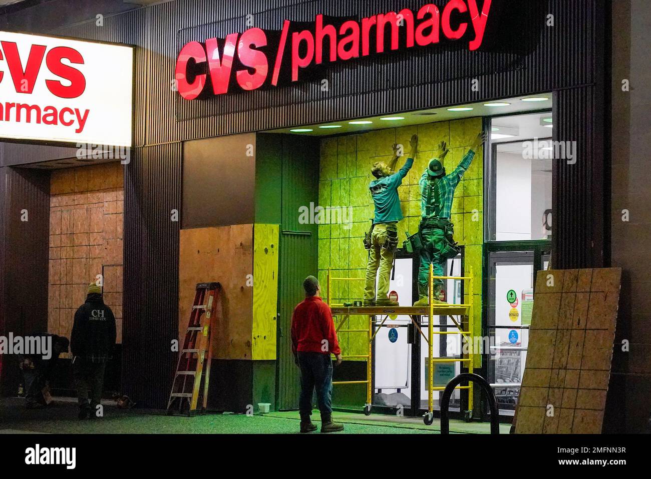 The windows of a downtown Pittsburgh CVS Pharmacy are boarded up on ...