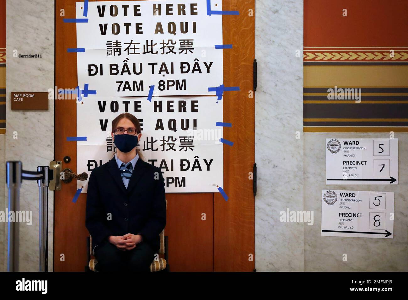 A Boston Public Library security guard sits at the entrance to a ...