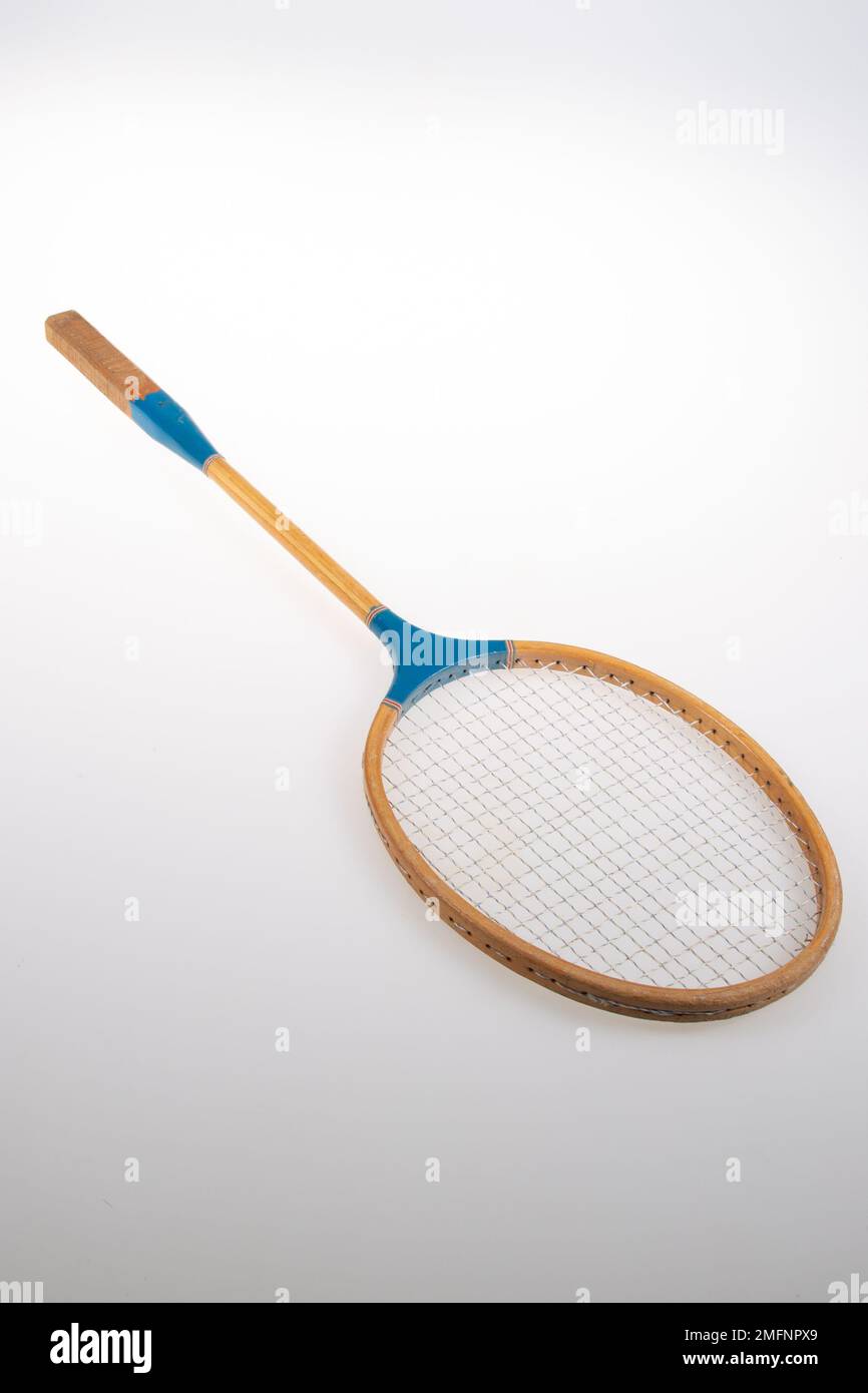 Vintage badminton rackets in wooden and blue plastic over grey background Stock Photo