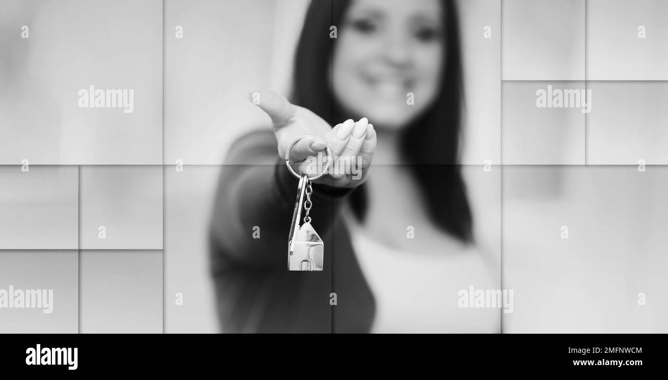 Young woman holding out house keys, light effect, geometric pattern