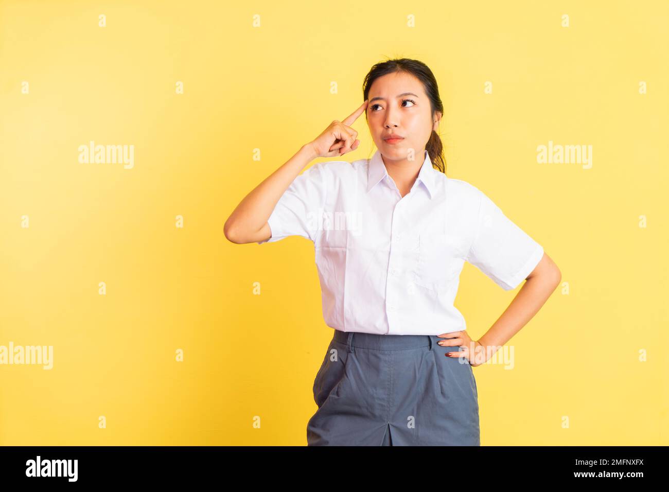 thinking expression of teenage girl in high school uniform Stock Photo