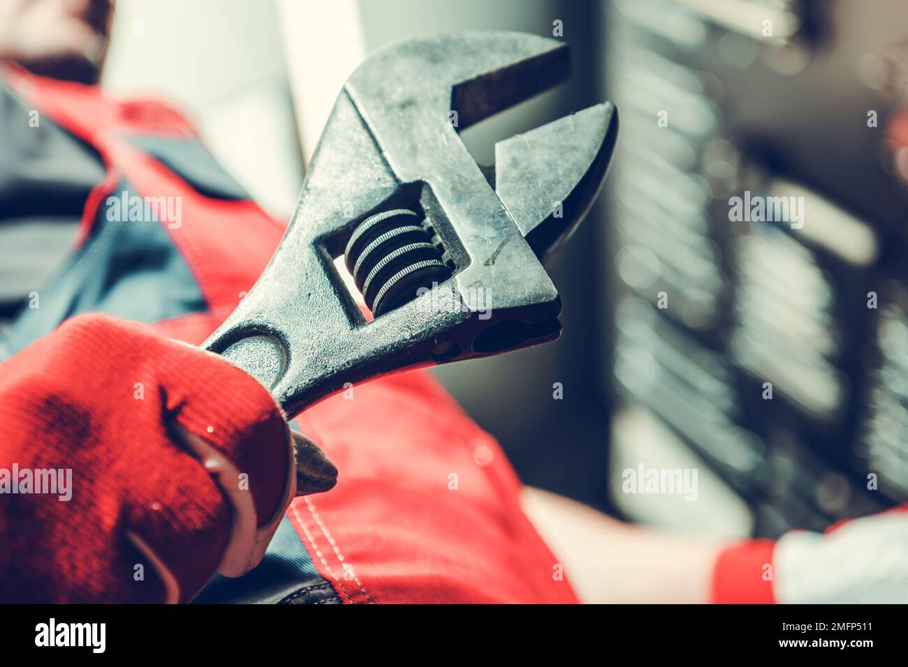 Industrial Worker with Large Adjustable Wrench in His Hand Preparing