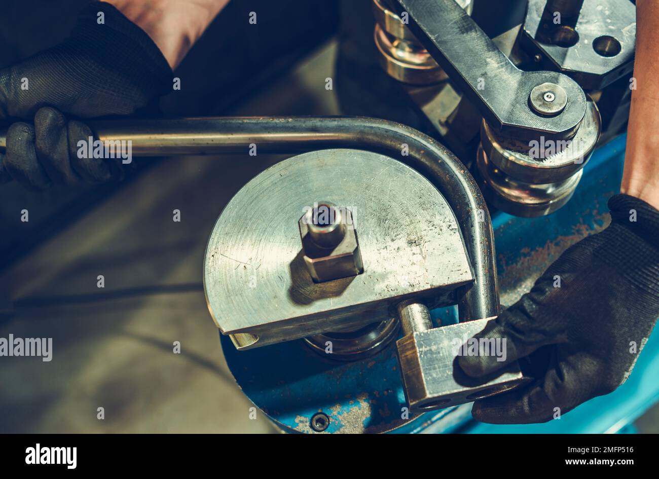 Manual Metal Pipe Bending Machine. Metalworking Worker Bending Piece of