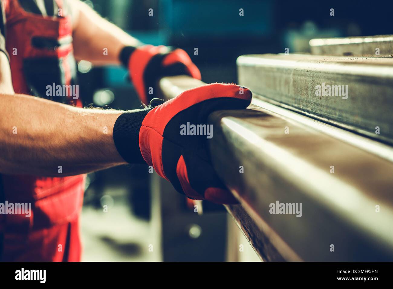Metalworking Shop Worker Taking Piece of a Metal Square Tube Close Up