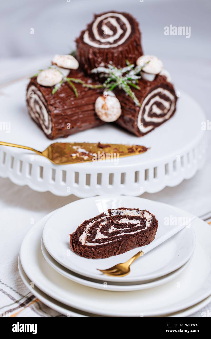 French dessert called Yule log or bûche de Noël with merengue mushrooms