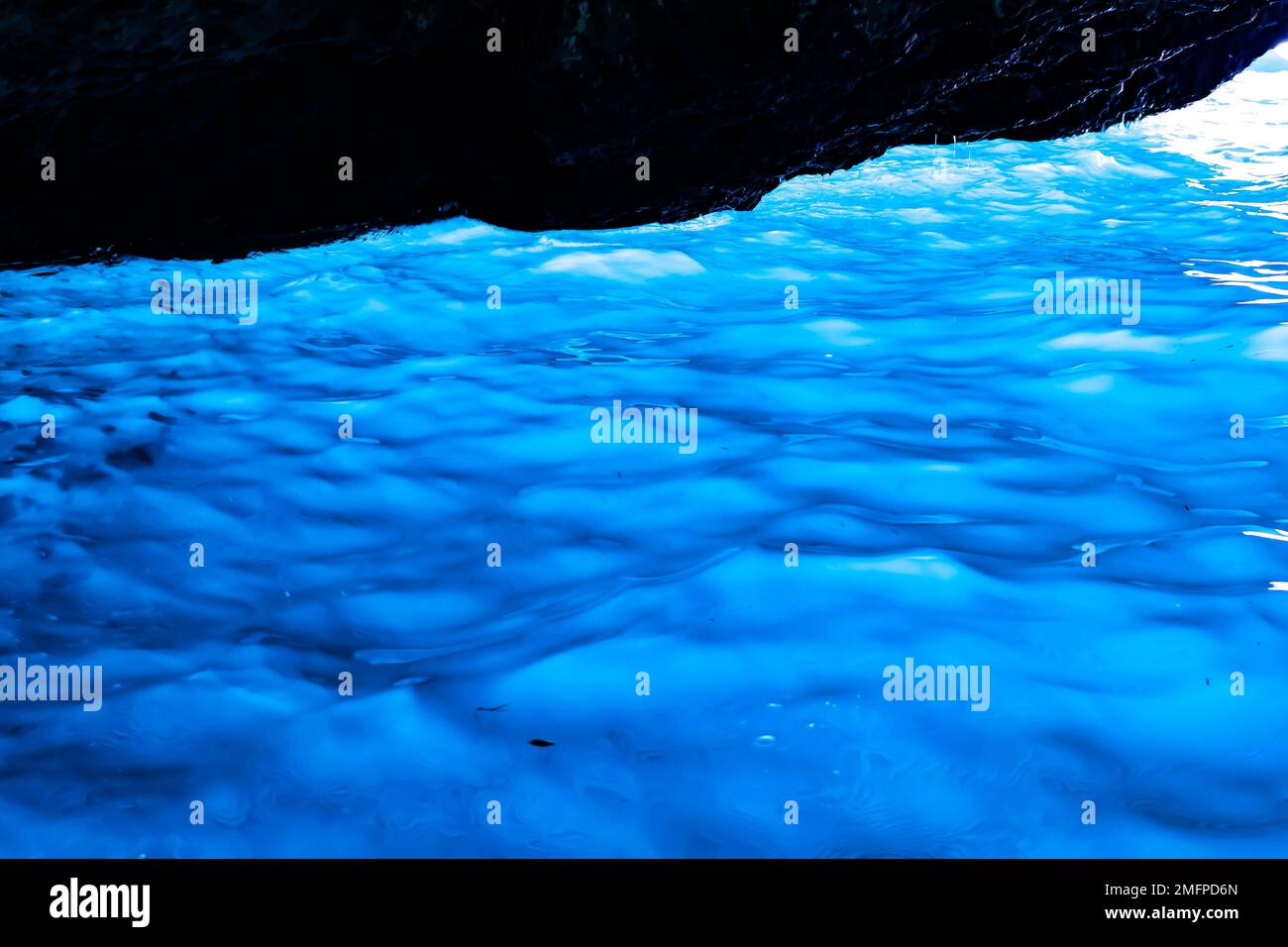 View of light blue water naturally lit from below, inside a sea cave at Porto Vromi, Zante