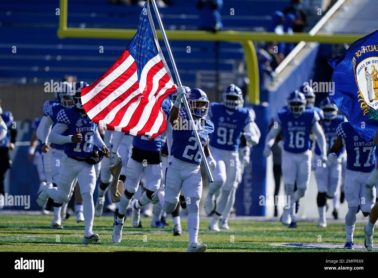 Kentucky players run onto the field before an NCAA college football