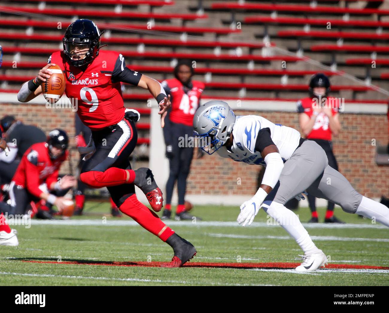 Cincinnati quarterback Desmond Ridder (9) scrambles away from Memphis ...