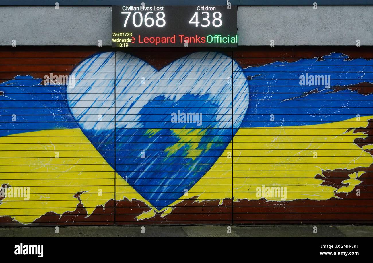 A electronic ticker tape above a mural in support of Ukraine in Dublin's city centre announces that dozens of Nato's modern battle tanks are to be sent to Ukraine to bolster the fight against Vladimir Putin's invasion, ending weeks of diplomatic deadlock over the supply of armour to the country. Picture date: Wednesday January 25, 2023. Stock Photo