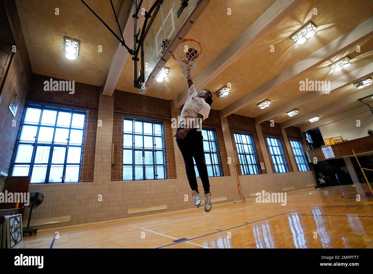 Kenny Scottborough, 19, goes up for a shot in an empty gymnasium at West  Brooklyn Community High School, Thursday, Oct. 29, 2020, in New York. The  high school is a "transfer school,"
