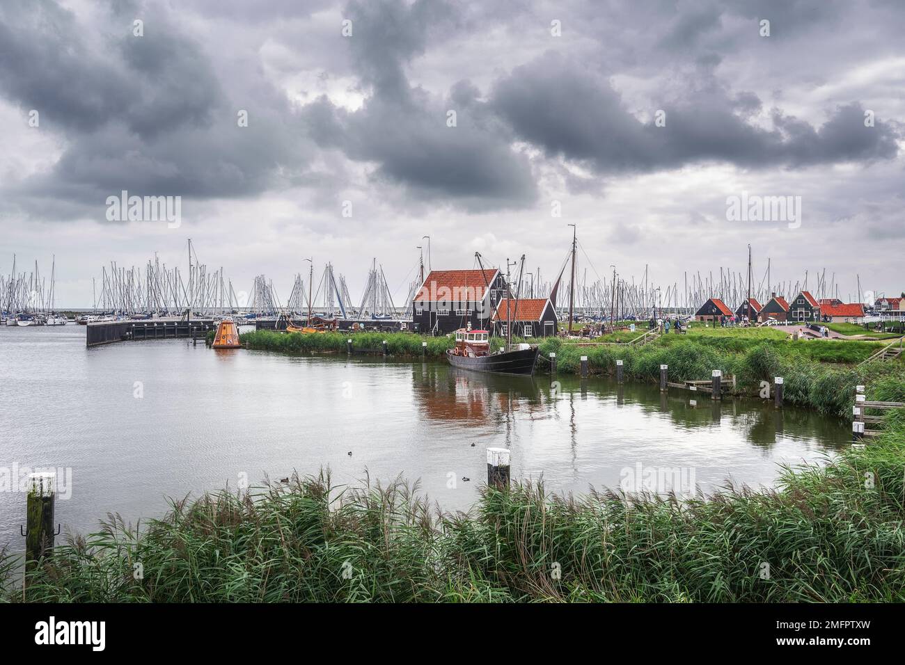 Enkhuizen, Netherlands - August 18,2021: Traditional fishing village with small houses, a church and ships in Enkhuizen, North Holland in the Netherla Stock Photo