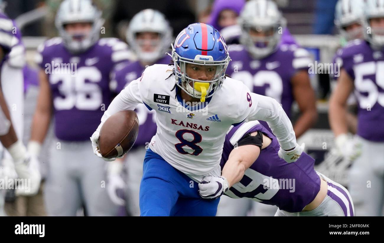 Kansas wide receiver Kwamie Lassiter II (83) catches a touchdown pass while  covered by Oklahoma State safety Jarrick Bernard (24) during the first half  of an NCAA college football game in Lawrence