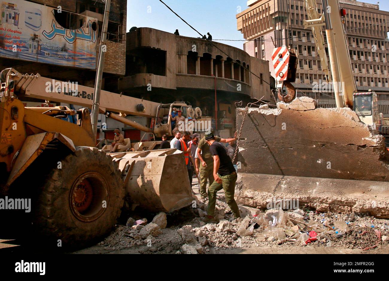 Iraqi security forces remove concrete blocks to open roads near the ...