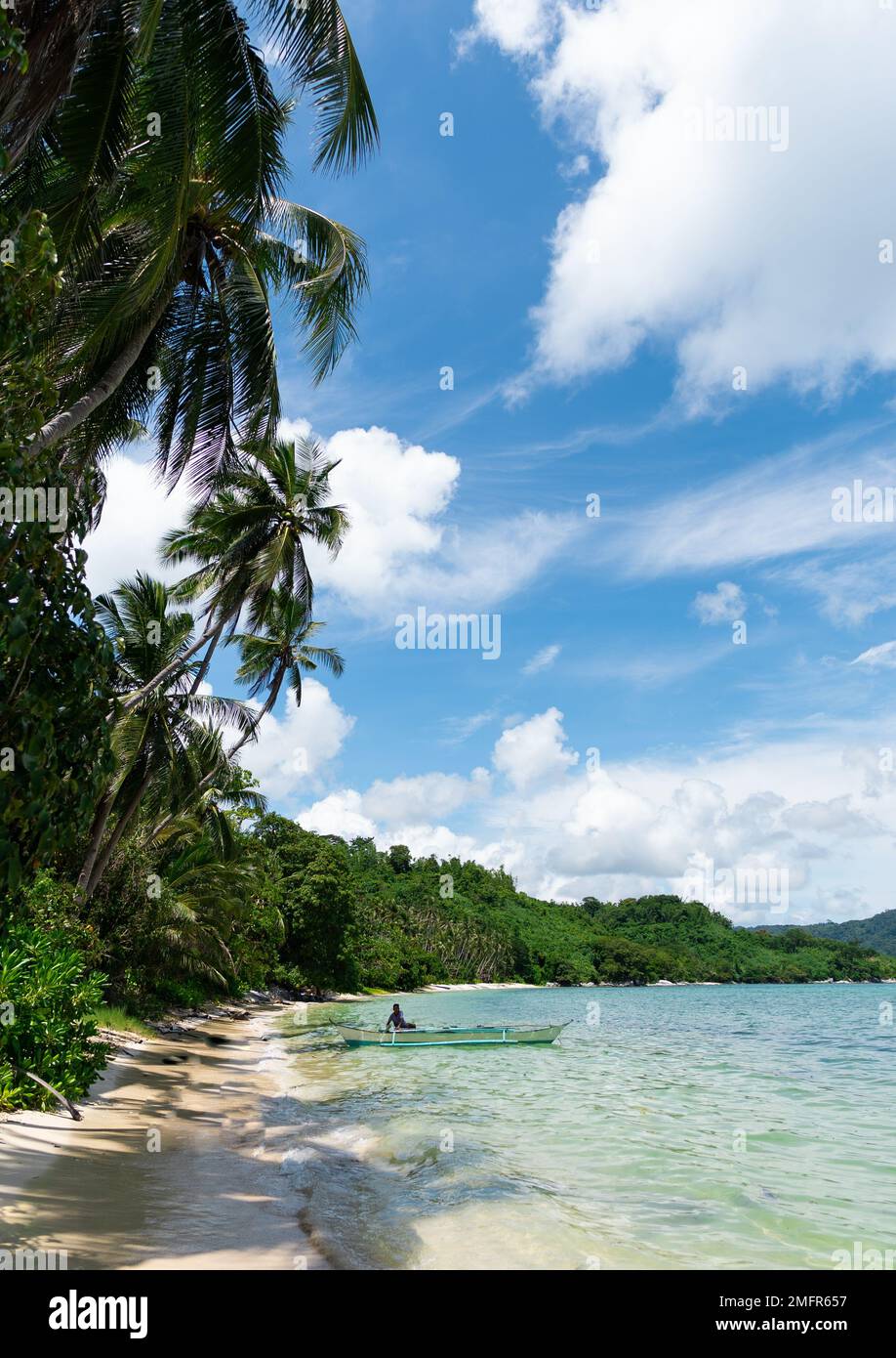vertical photo of fisherman preparing his boat to go fishing in a
