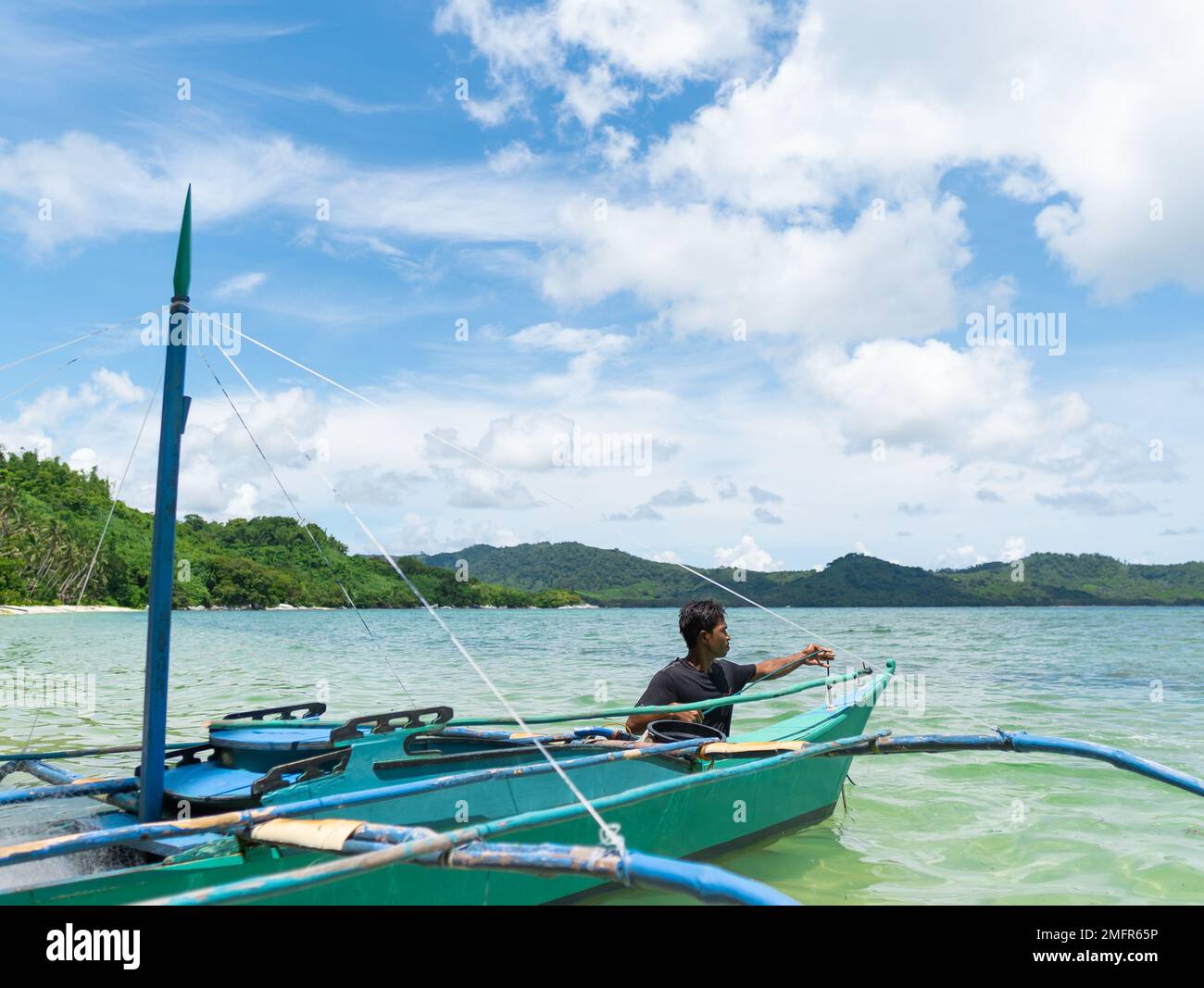 fisherman fixing his anchor, after going out to fish in a Filipino