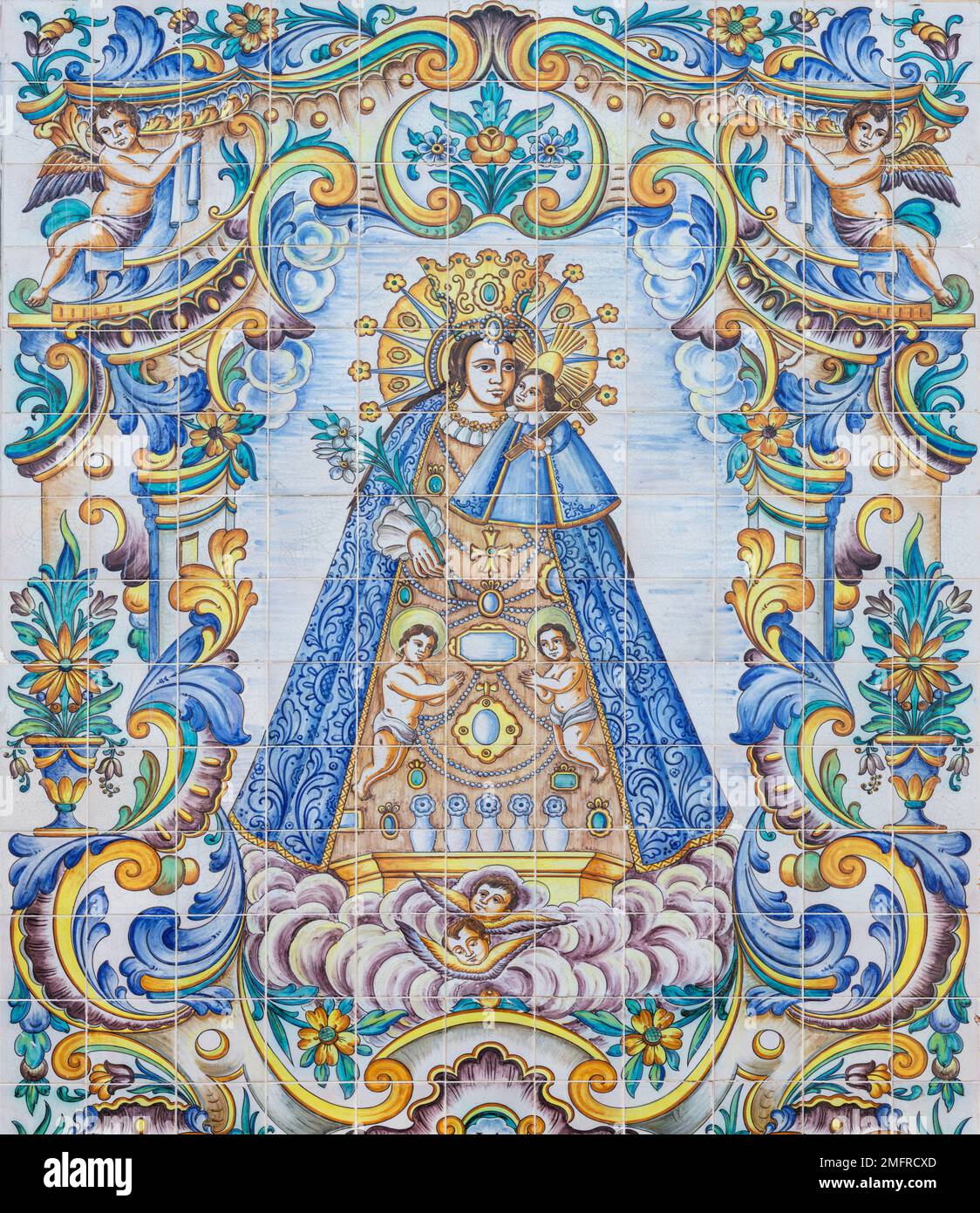 VALENCIA, SPAIN - FEBRUAR 17, 2022: The ceramic tiled Madonna on the facade of church Basilica de la Mare de Deu dels Desamparats by J. Gimeno 20.cent Stock Photo