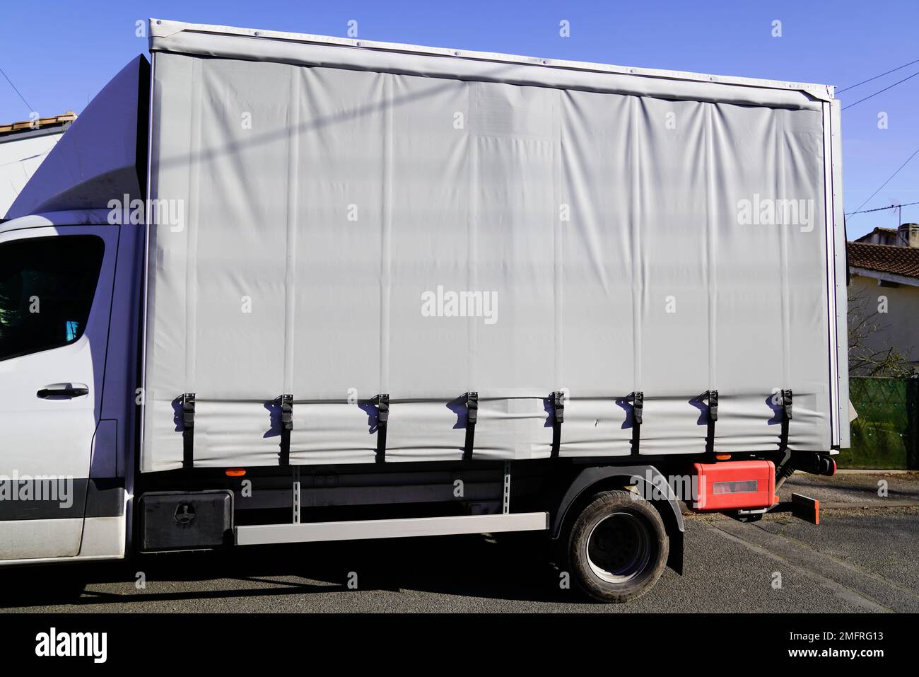 covered truck with grey tarpaulin for mockup gray empty place Stock Photo