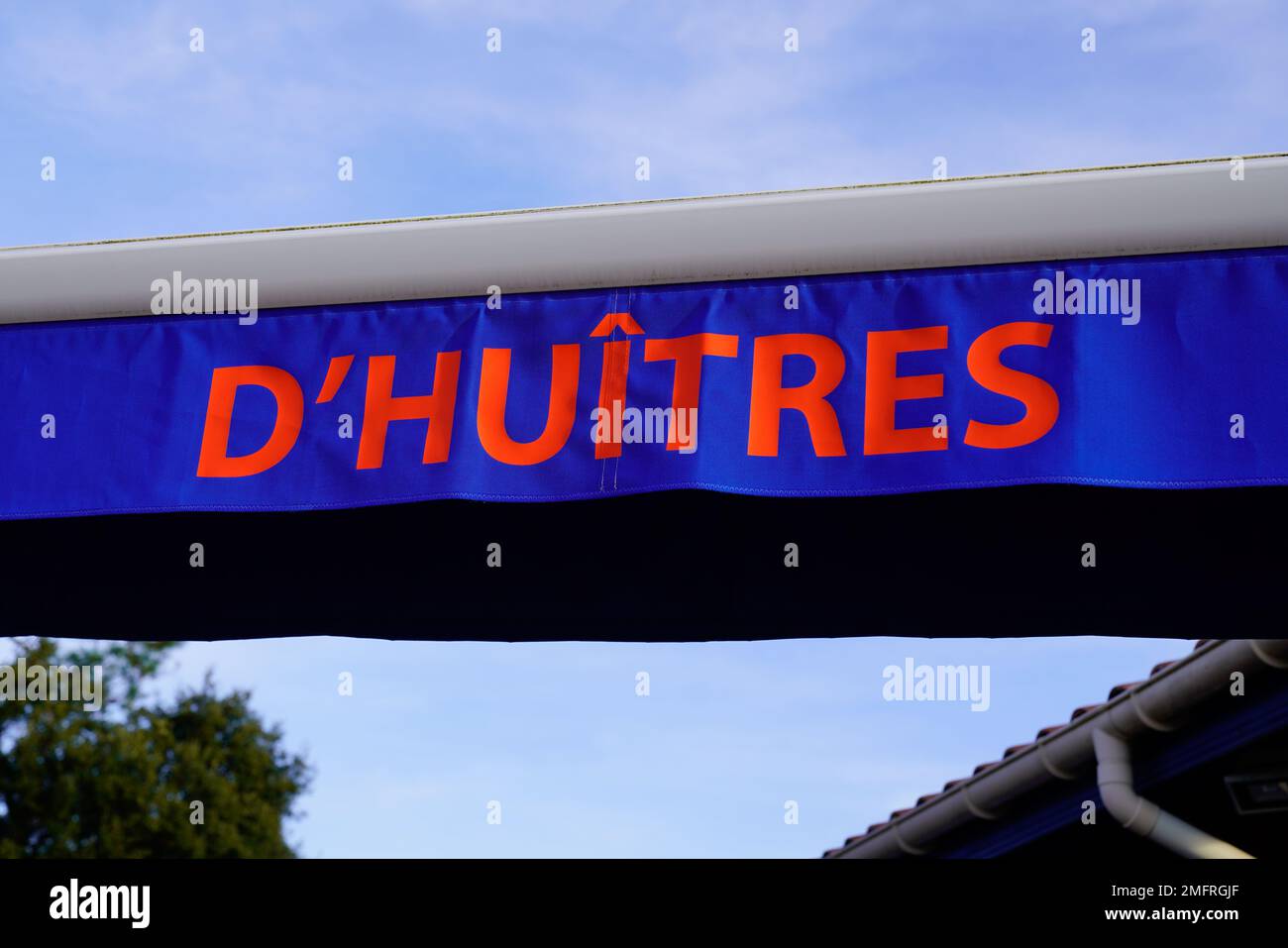 oysters huitres text in French on a sun visor tarp on the terace of an