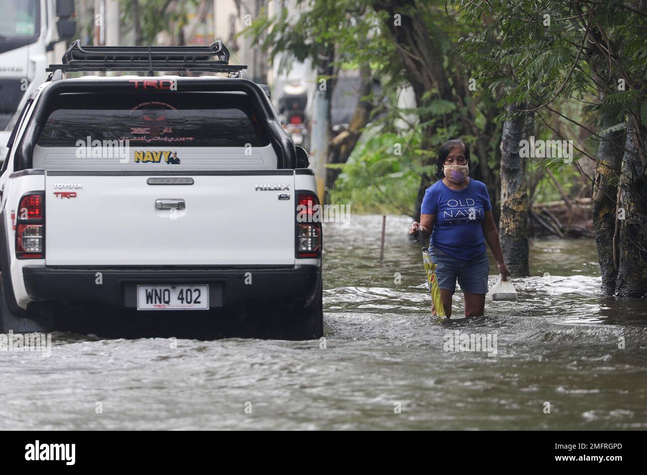 A resident negotiates a flooded road due to Typhoon Molave in Pampanga