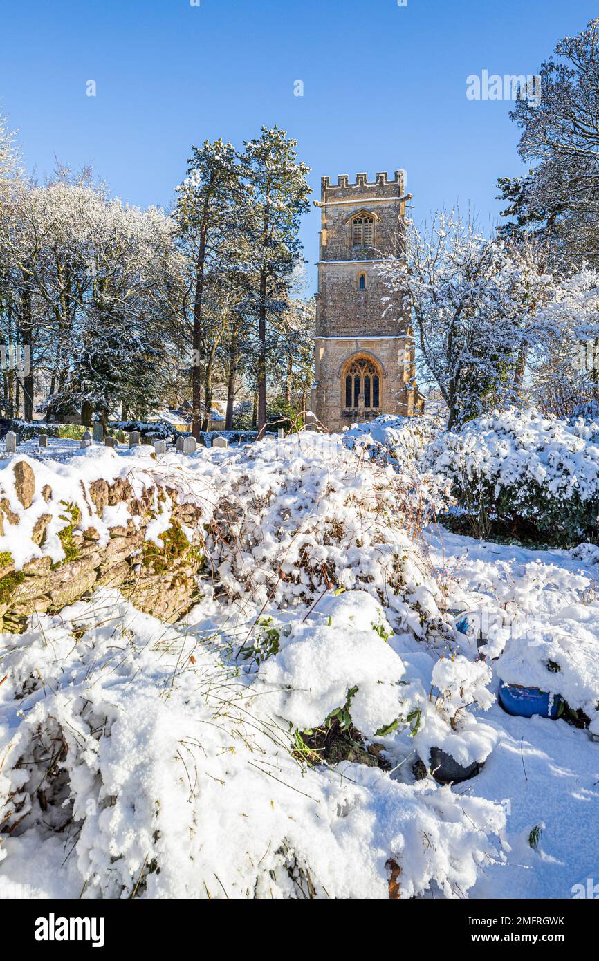 Early winter snow at the church of St John the Evangelist in the Cotswold village of Elkstone