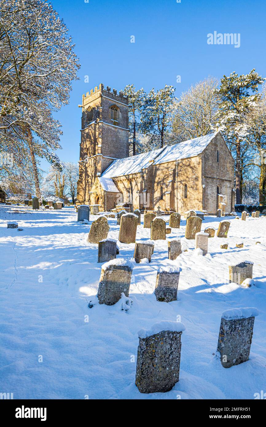 Early winter snow at the church of St John the Evangelist in the Cotswold village of Elkstone, Gloucestershire, England UK Stock Photo