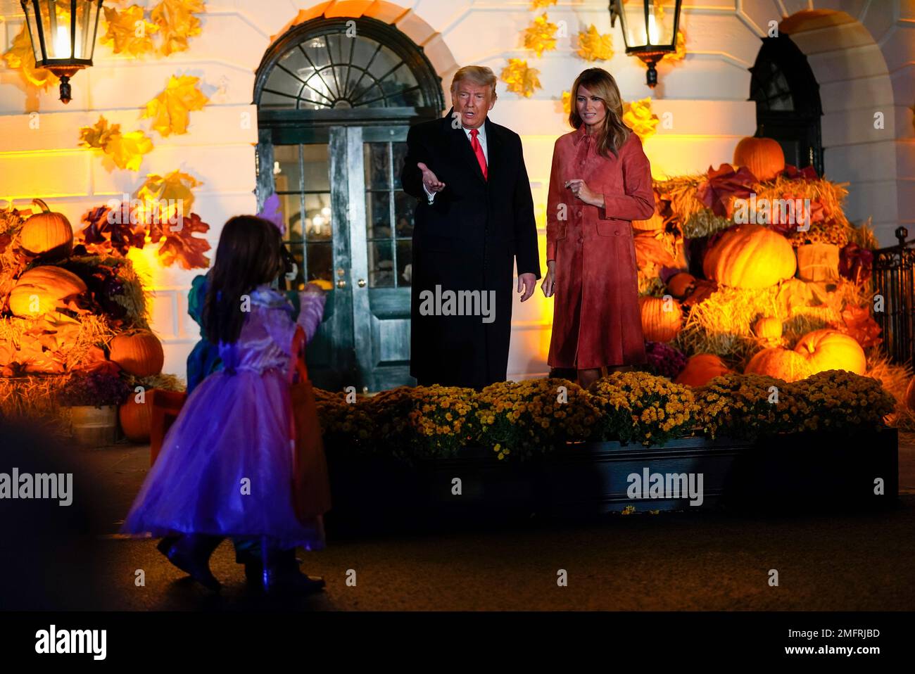 President Donald Trump and first lady Melania Trump greet trickor