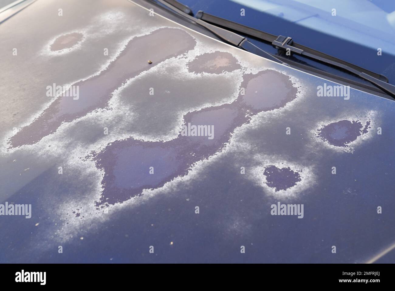 old car engine hood blue green used paint worn by time and sun