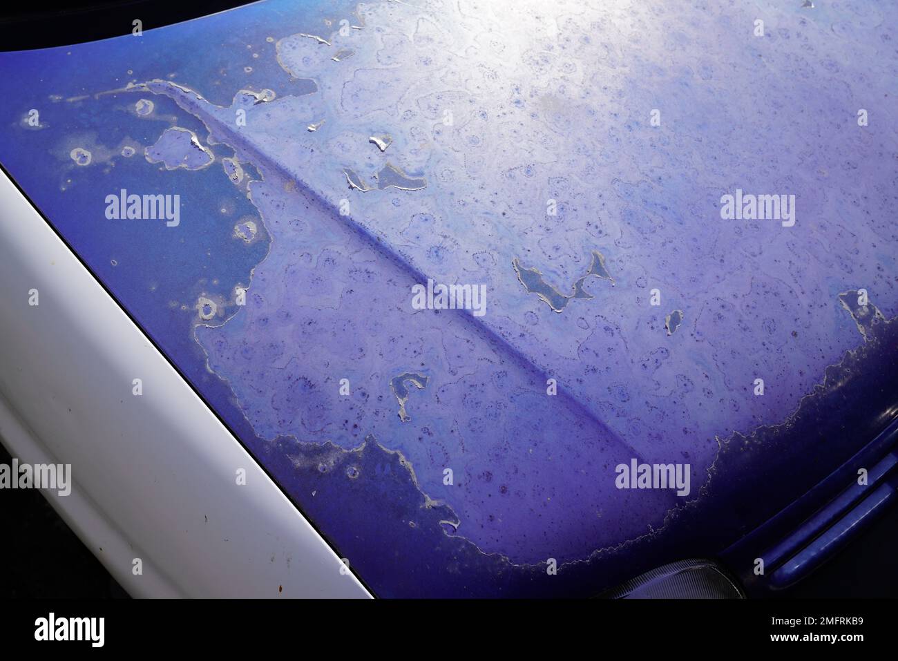 front peeling worn cracked blue paint with scratches car old used completely faded engine hood