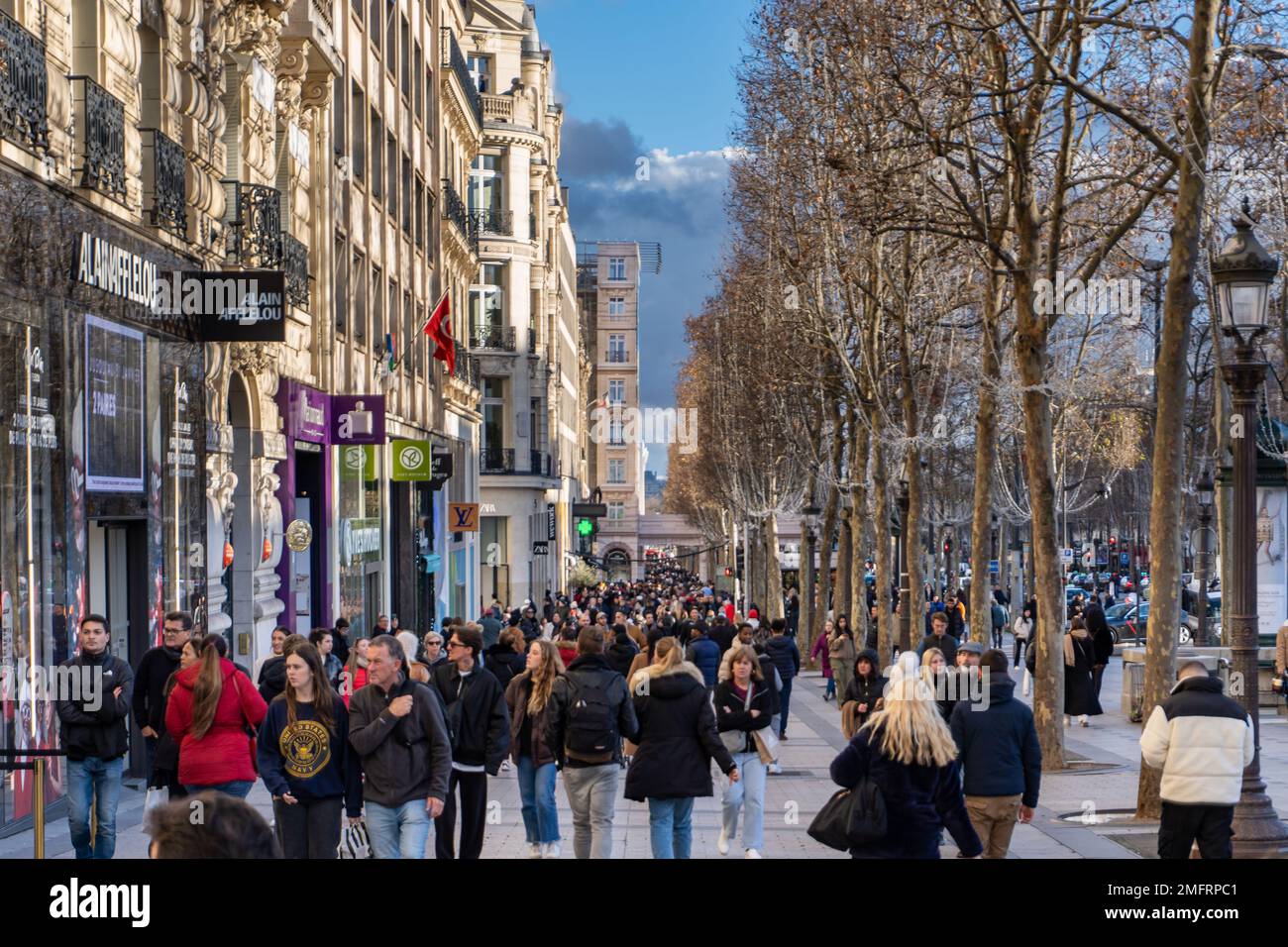 A busy winter afternoon on the sidewalks of the Champs Élysées in Paris. A busy winter afternoon on the sidewalks of the Champs Élysées in Paris. Stock Photo