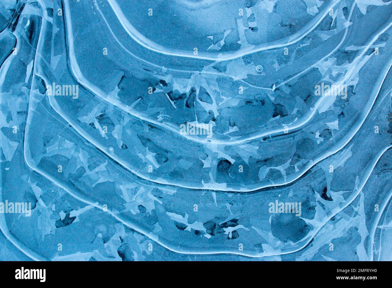 Ice pattern formation on a small woodland pond in Pebnnsylvania's Pocono Mountains Stock Photo