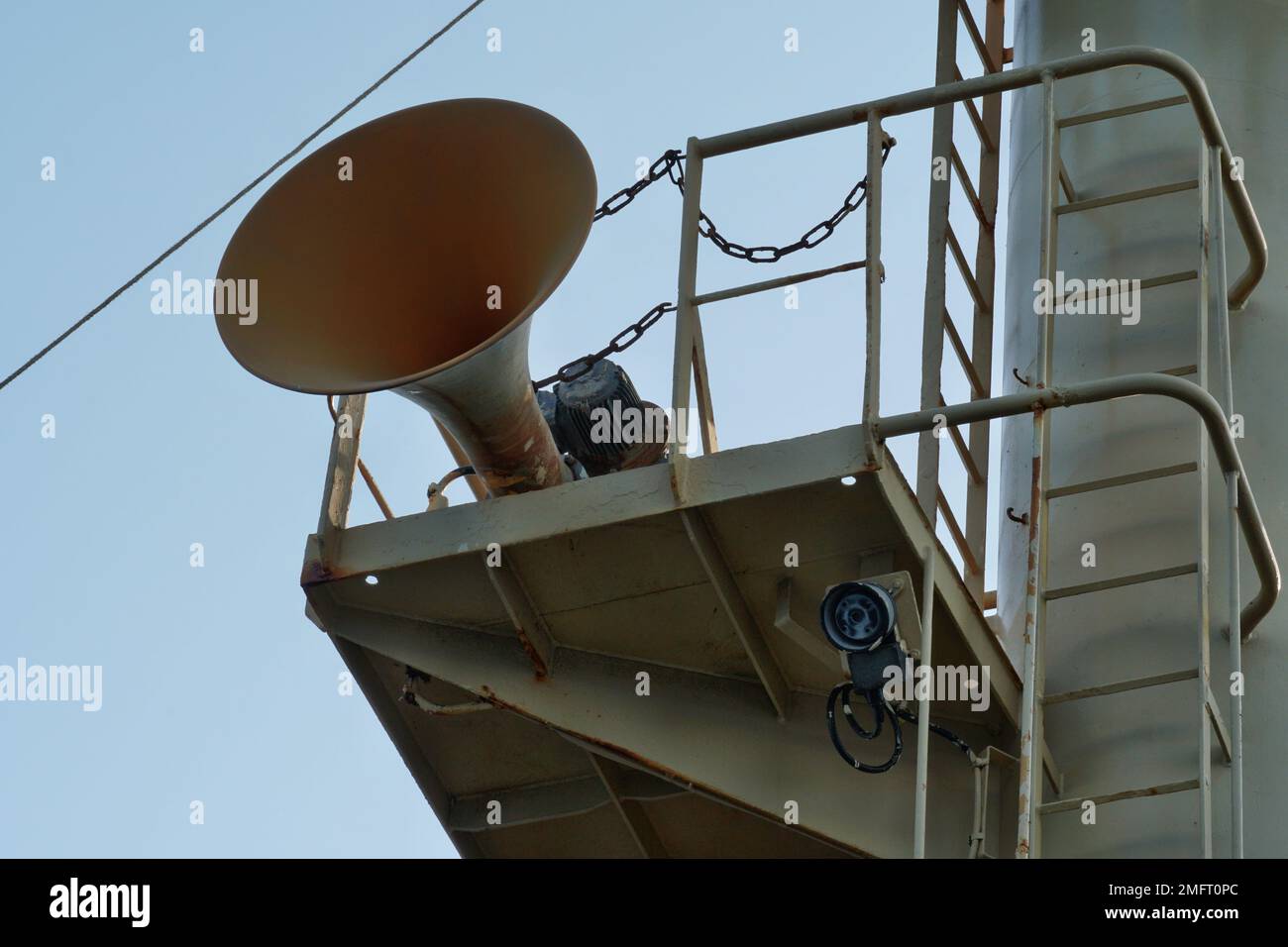 View on foghorn attached in platform of forward vessel mast with ladder from mooring station, from deck to top. Stock Photo