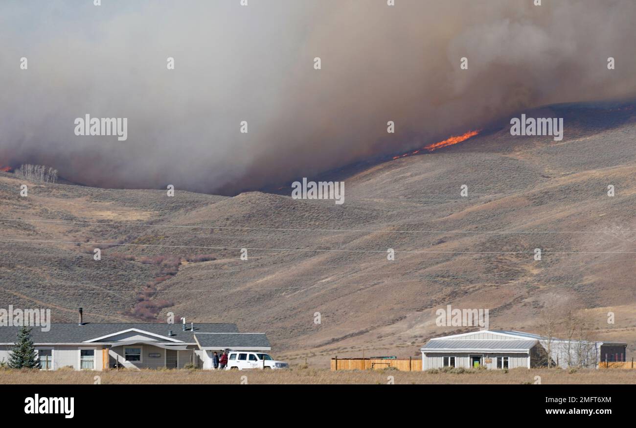 Smoke rises on mountain ridges as a wildfire burns Thursday, Oct. 22 ...