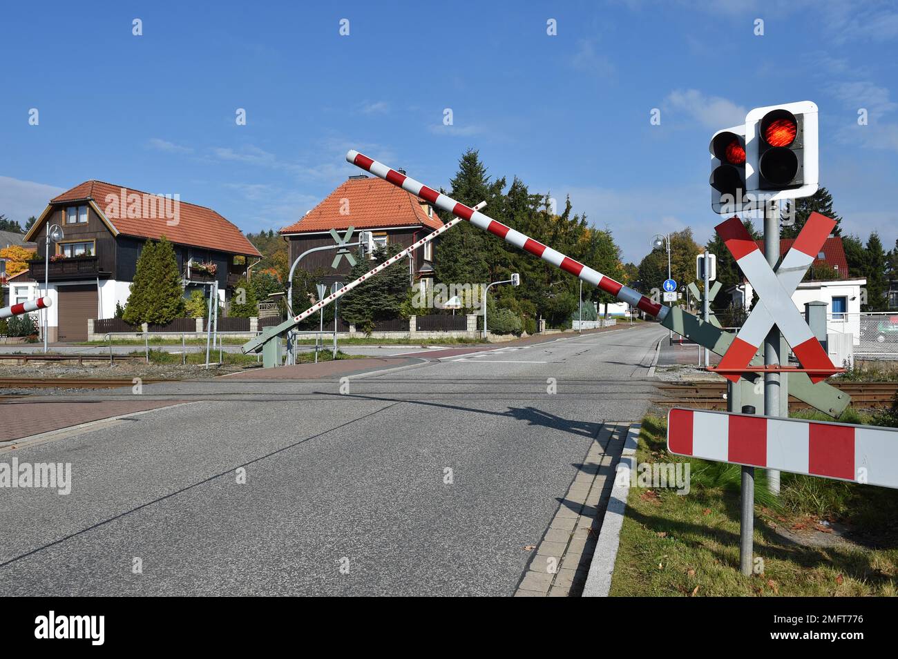 Railway barrier and St. Andrews cross at a level crossing of the Harzer Schmalspurbahn, HSB, in