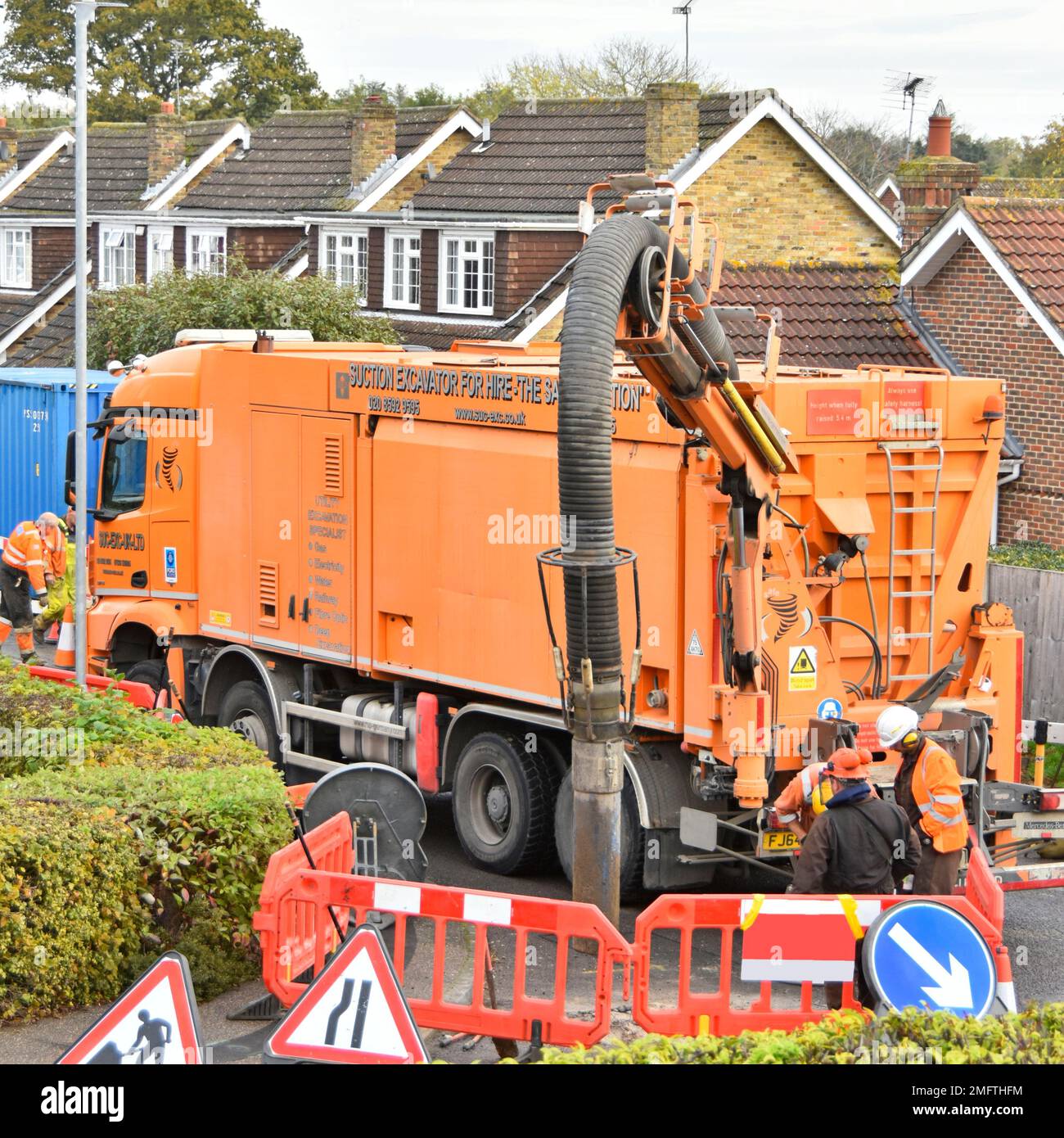 Workmen use suction excavator by German business RSP on hgv Mercedes lorry truck quickly creating single earth pit to expose underground gas main UK Stock Photo