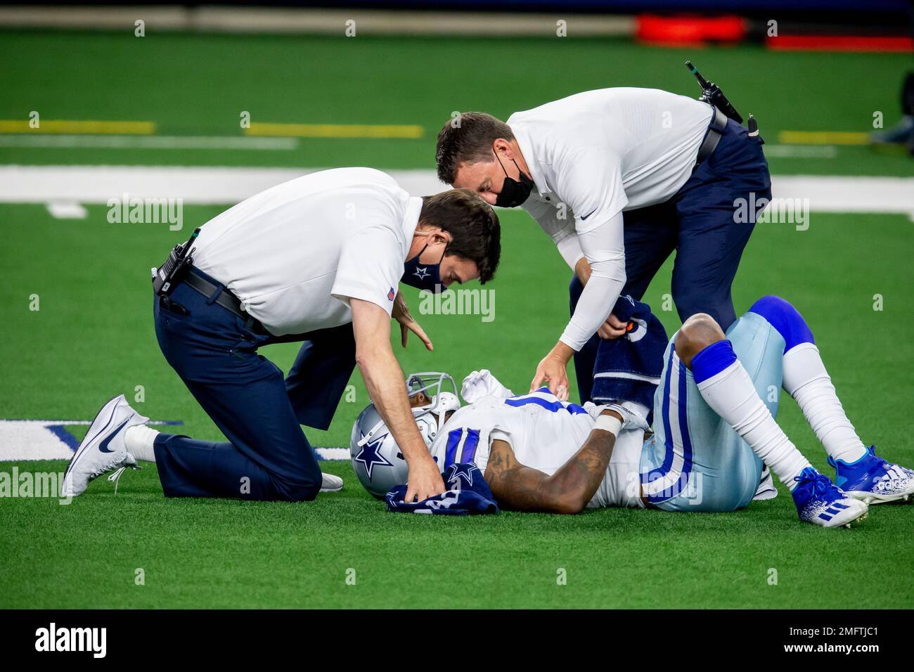 Trainers tend to Dallas Cowboys wide receiver Cedrick Wilson (11