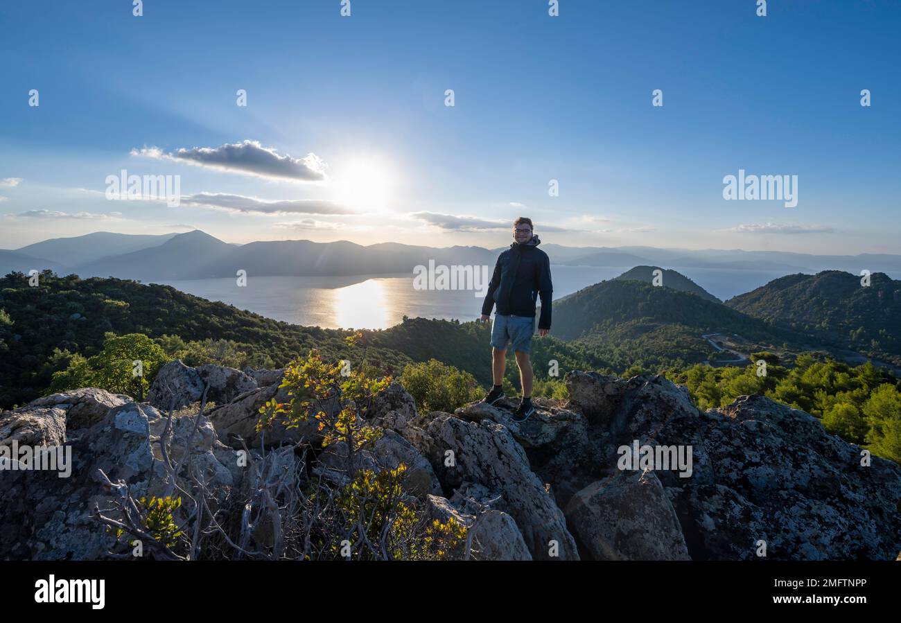 Hiker looking over volcanic peninsula Methana, view over sea and ...