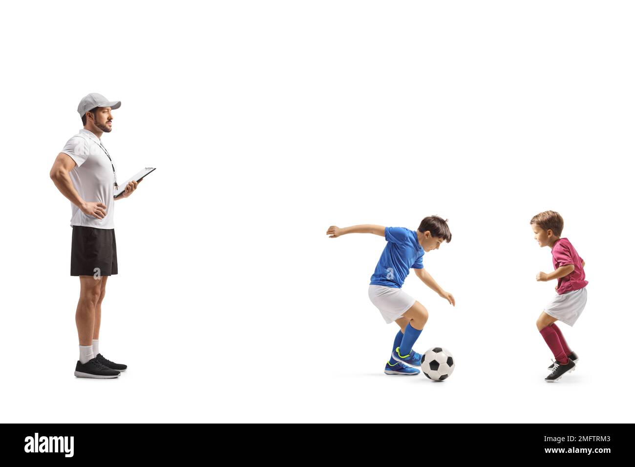 Coach watching two boys playing football isolated on white background Stock Photo