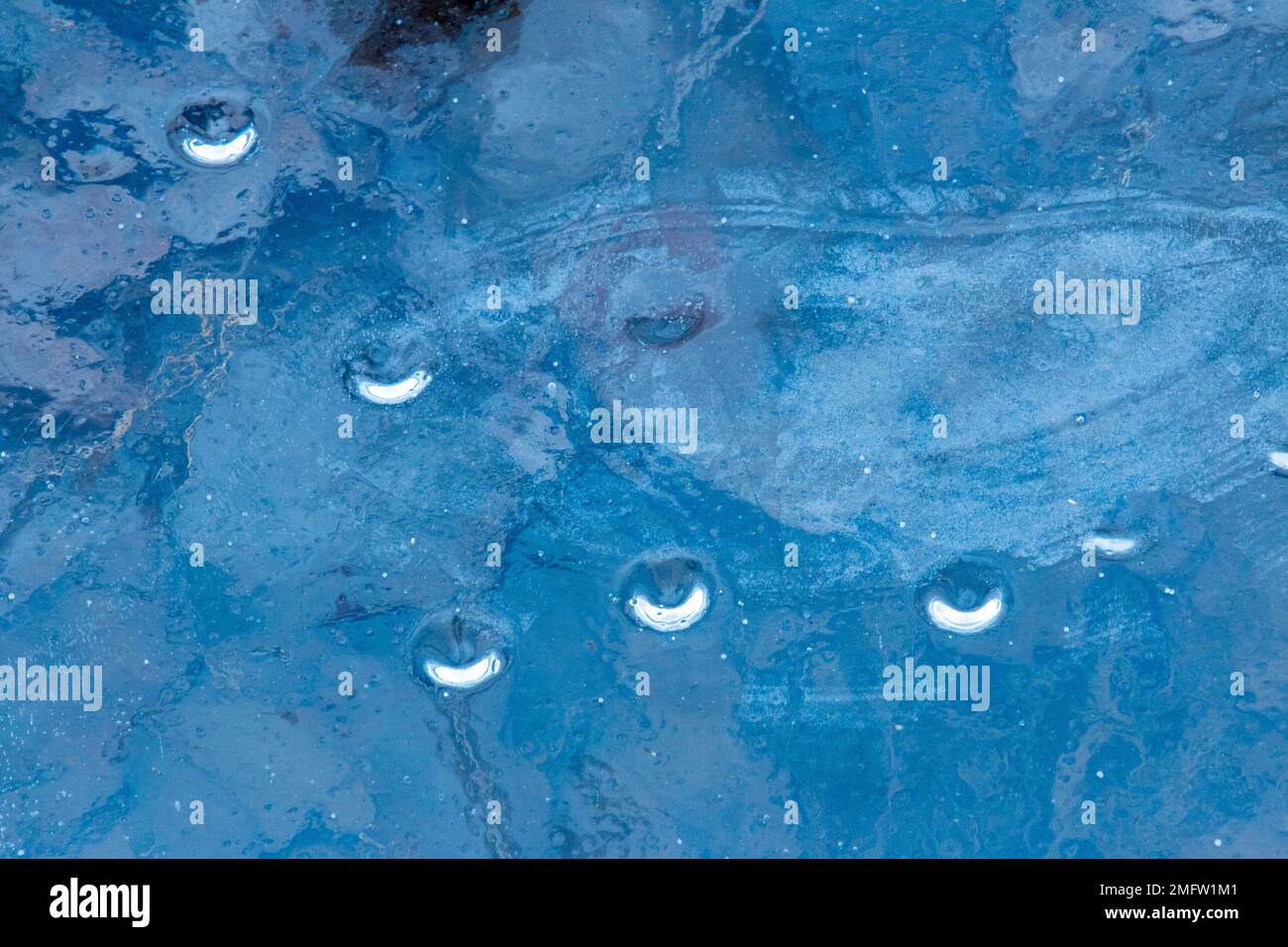 Ice pattern formation on a small woodland pond in Pebnnsylvania's Pocono Mountains Stock Photo