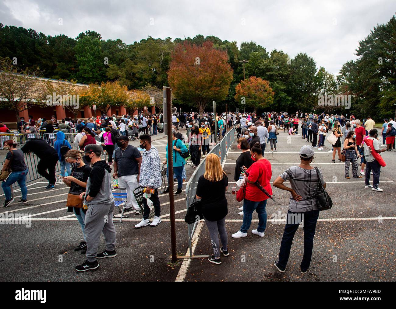 Hundreds of people wait in line for early voting in Marietta,