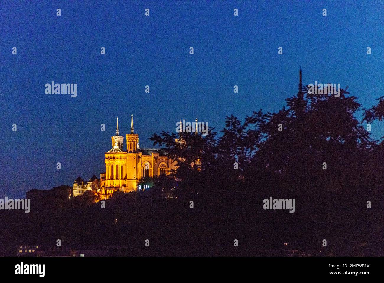 Basilica of Notre-Dame in Lyon, France at night from a distance Stock Photo