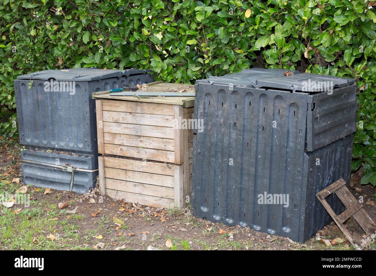 three Compost bin in the garden. Composting pile of rotting kitchen