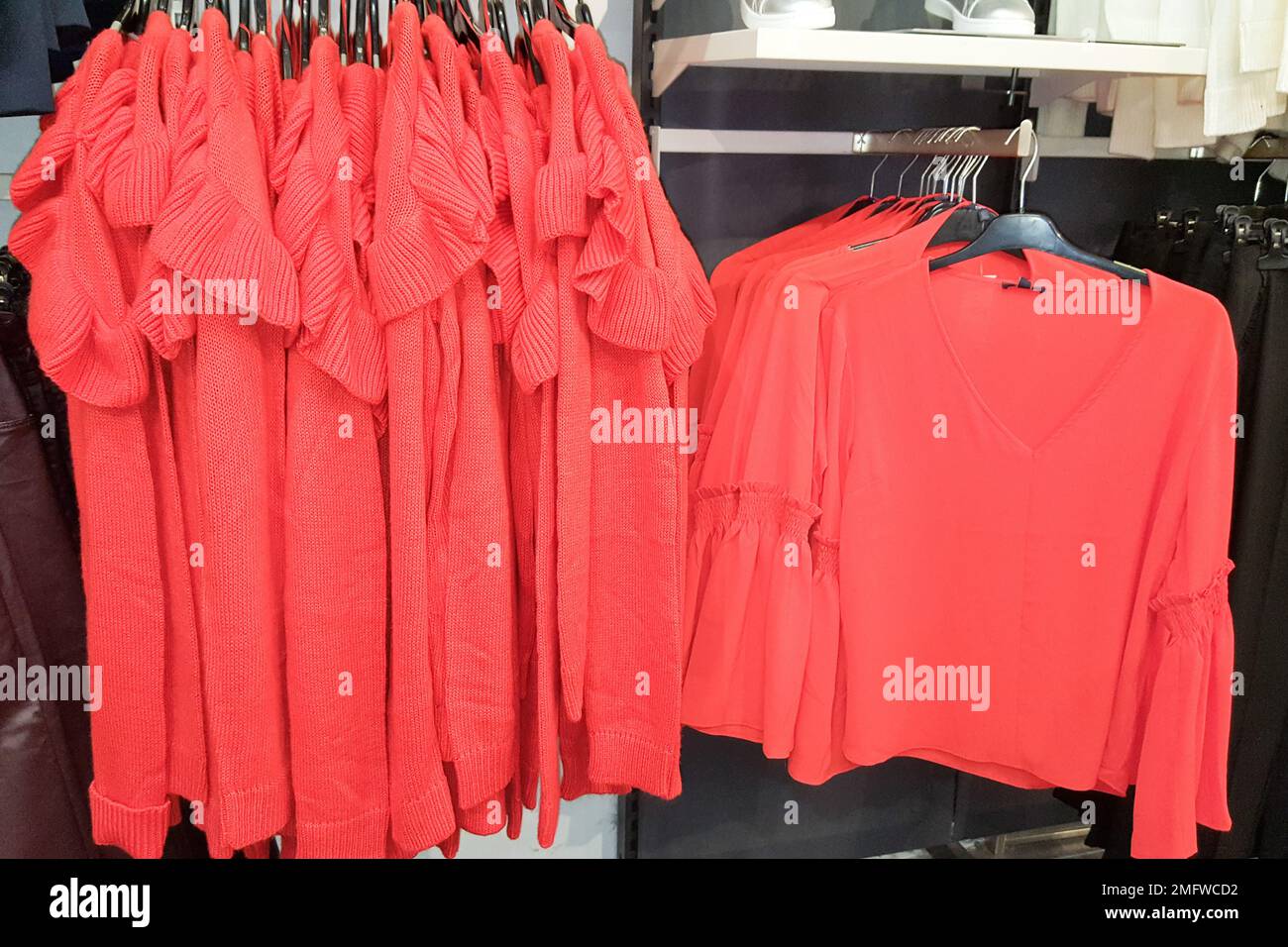 in the store top red clothes woman are presented Stock Photo - Alamy