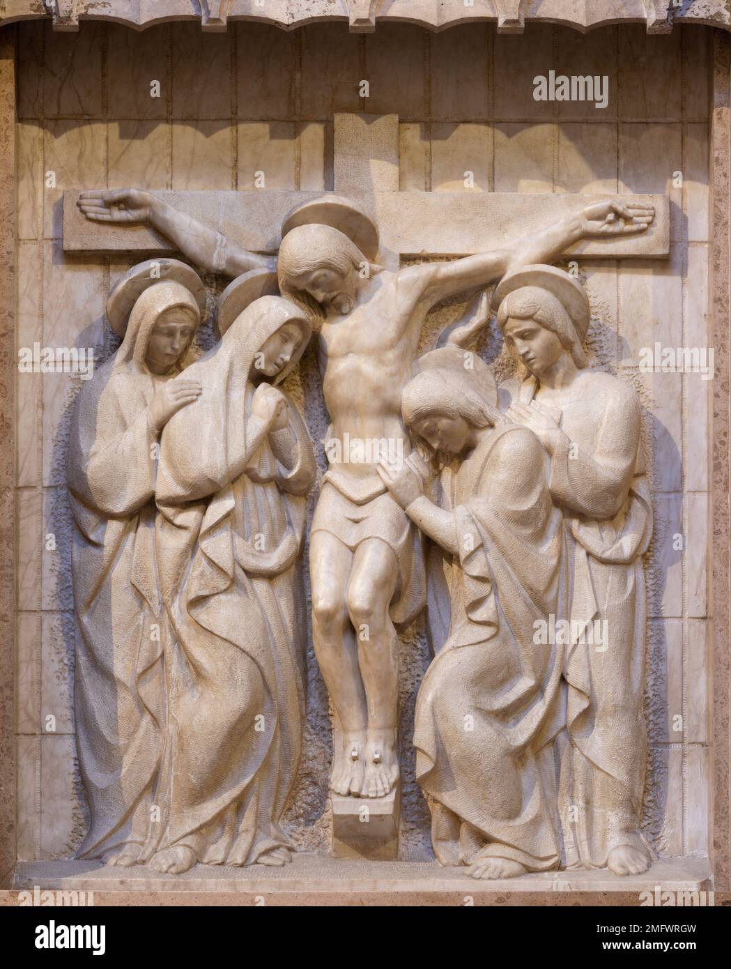 VALENCIA, SPAIN - FEBRUARY 17, 2022: The marble relief of Crucifixion in the church Basilica de San Vicente Ferrer from 20. cent. Stock Photo