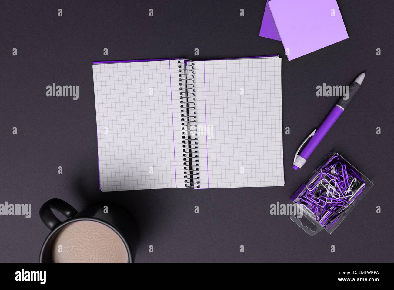 Coffee Cup Standing on Desk. Important infrormation written on paper. Different Office Supplies, Pencils, Pens, Marckers. Computer keyboard. Text on Stock Photo