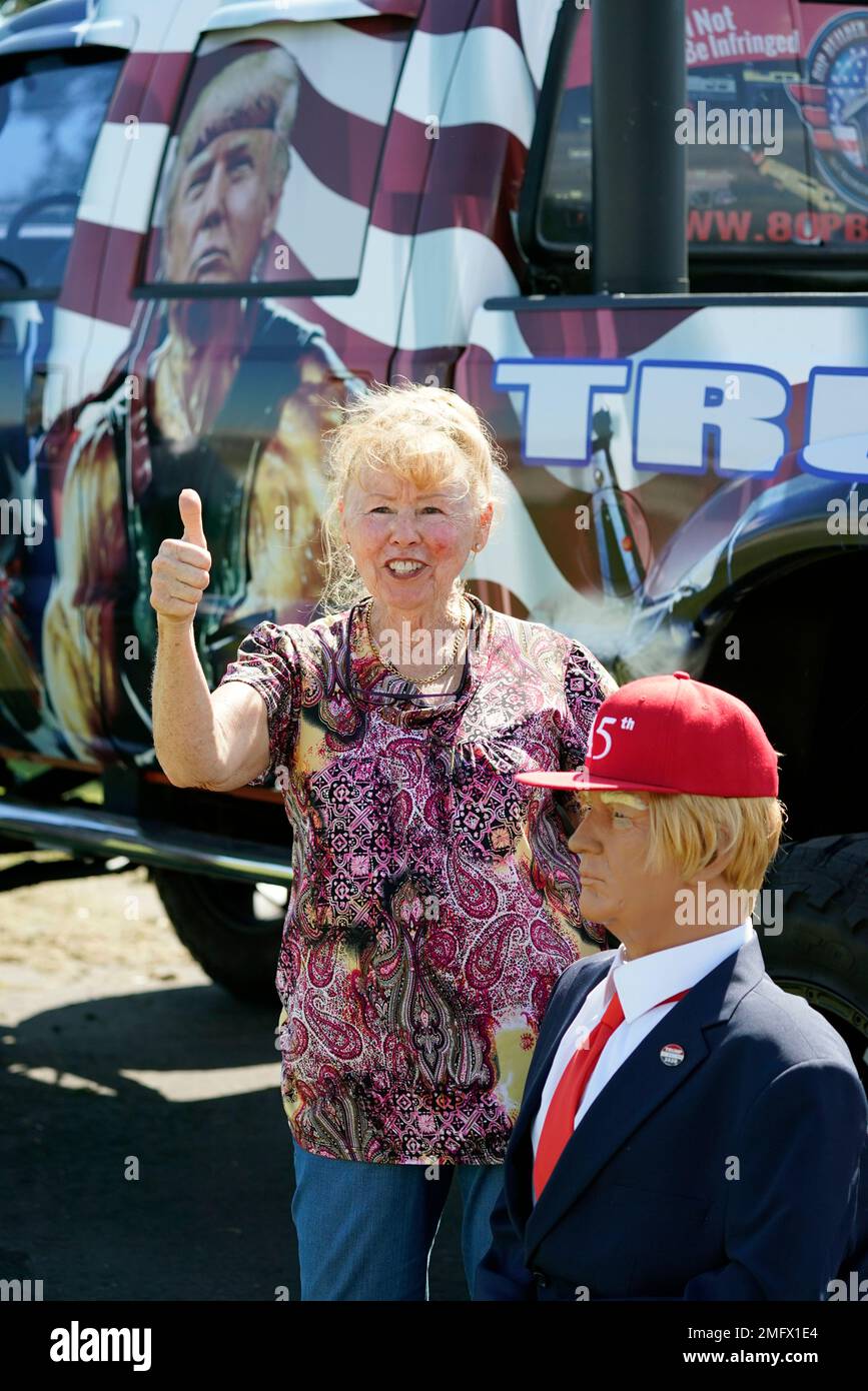 Christine Booth stands next to a mannequin dressed as President Donald